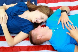 Couple laying on American flag who used a VA Loan